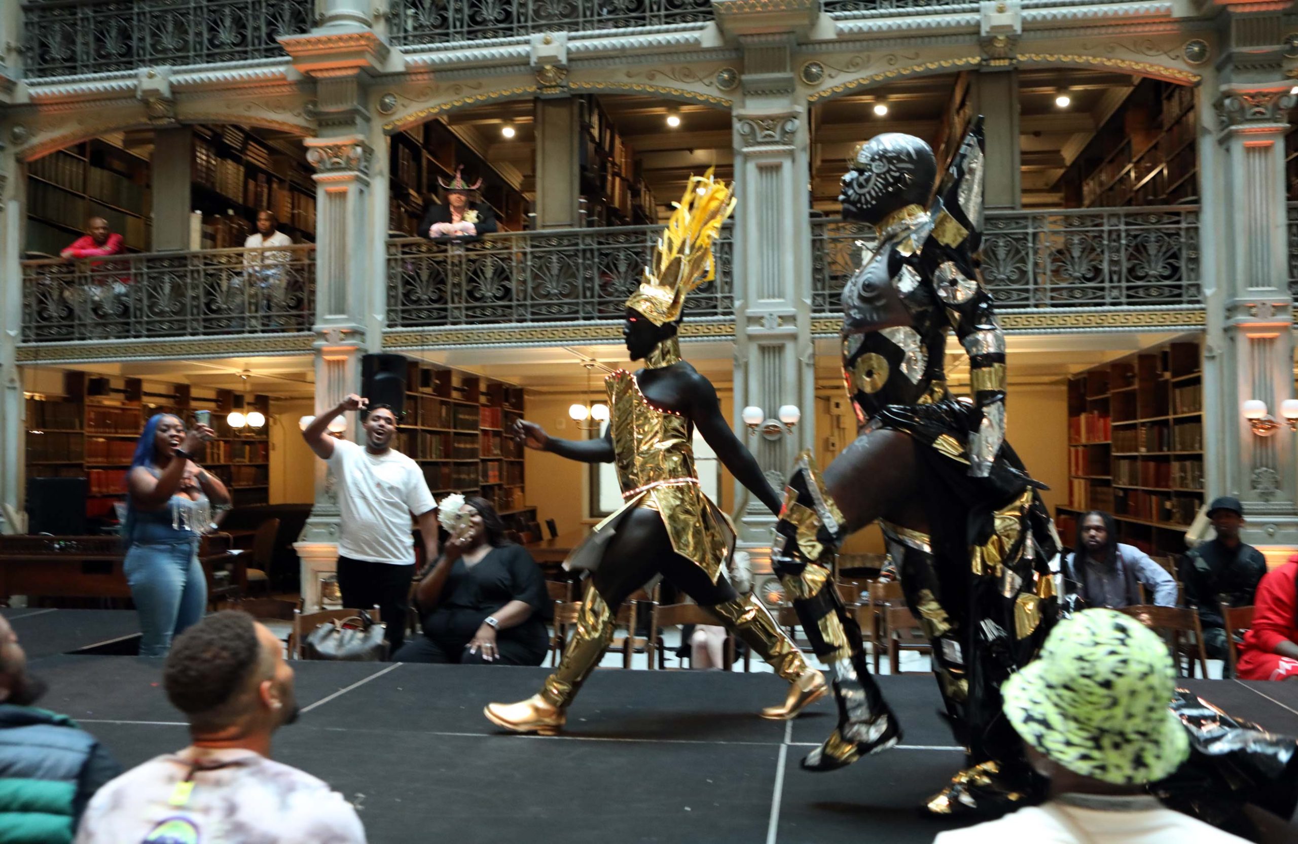 Two performers compete on the stage at the George Peabody Library
