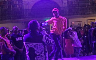 A performer on the stage at the George Peabody Library