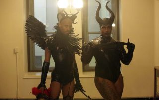 Two people posing in black costume