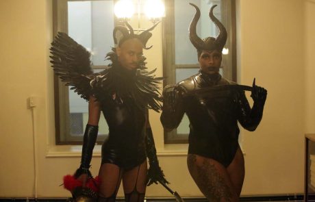Two people posing in black costume