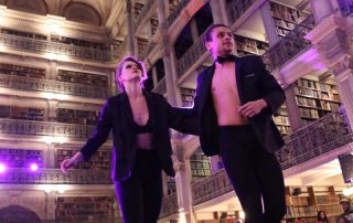 Two people in suits on a stage