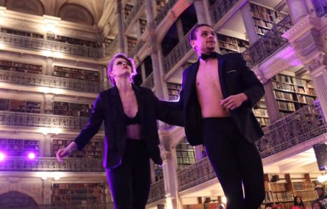 Two people in suits on a stage