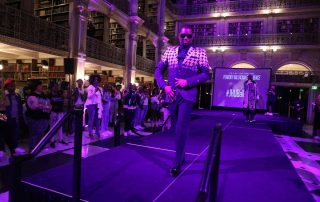 A performer on the stage at the George Peabody Library
