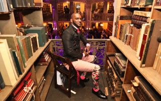 A person in a suit in between books