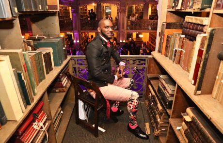 A person in a suit in between books
