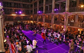 A large library and people on a stage