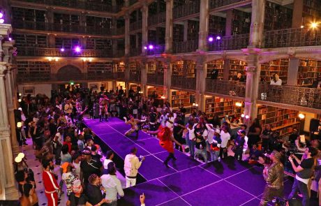 A large library and people on a stage