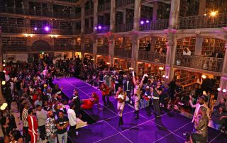 A large Library and people on a stage