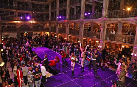 A large Library and people on a stage
