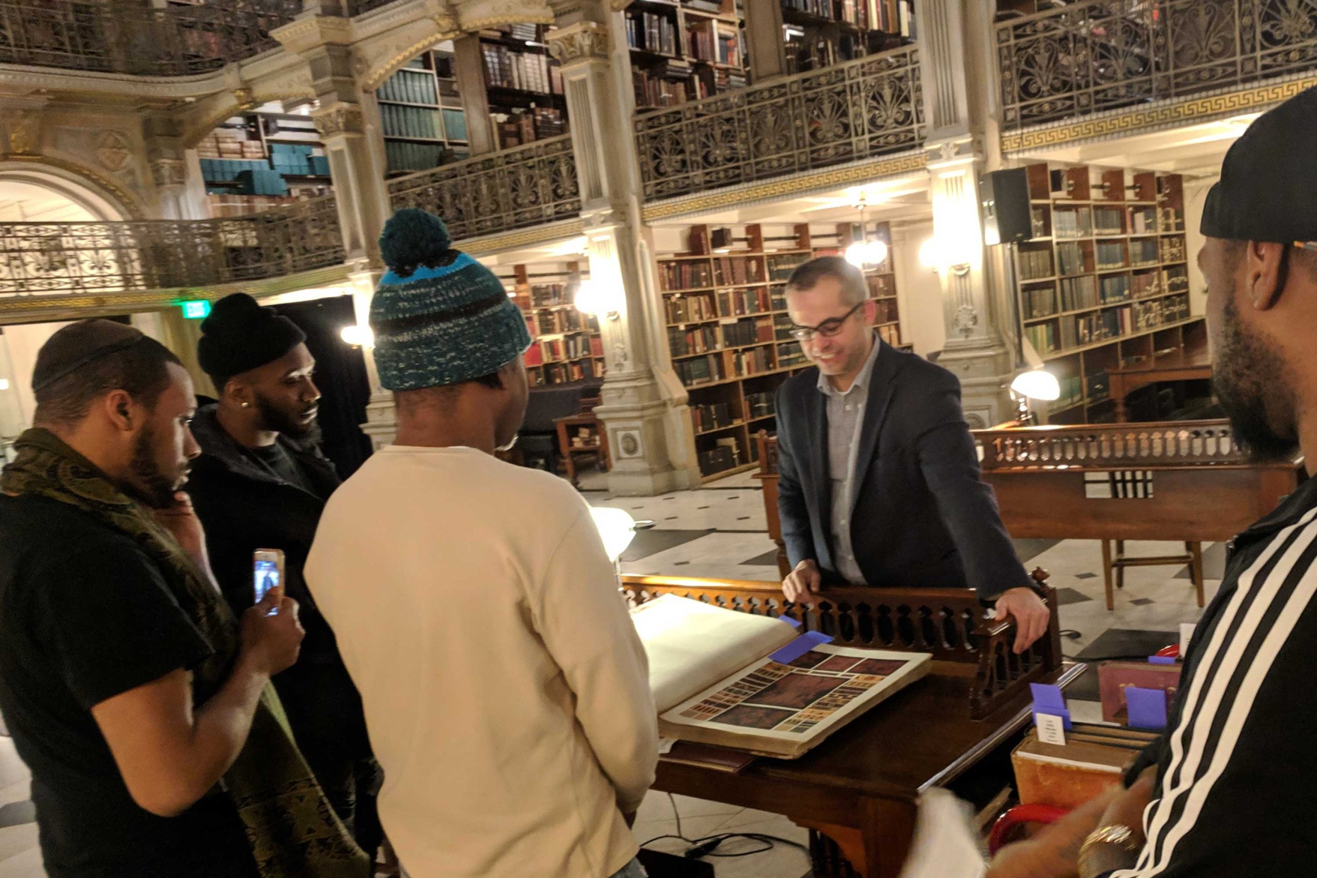 IMG_20190116_204318 people in front of a large book